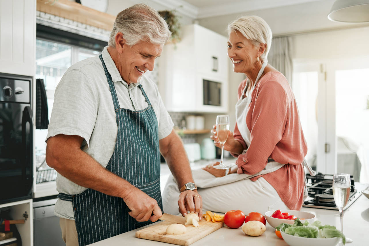 Older man and woman in a kitchen preparing meal