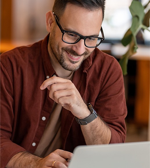 A man sitting in front of a laptop