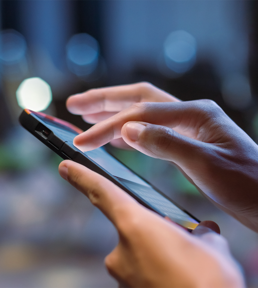 Hands holding and touching smartphone