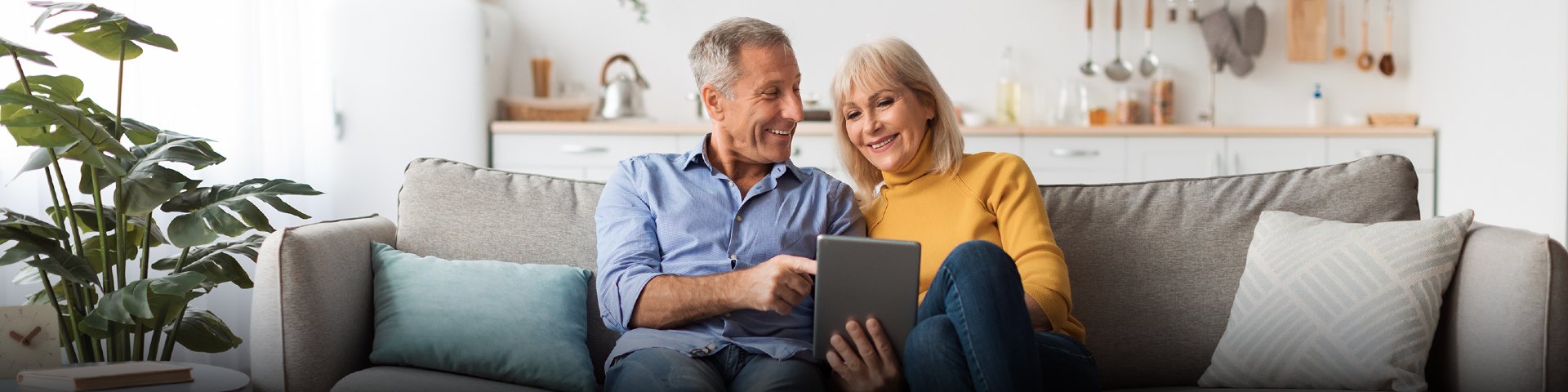 Man and woman on couch with iPad